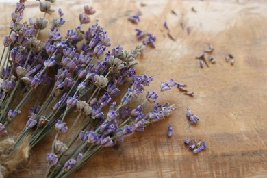 Photo of Bouquets of beautiful lavender flowers on wooden table, closeup. Space for text