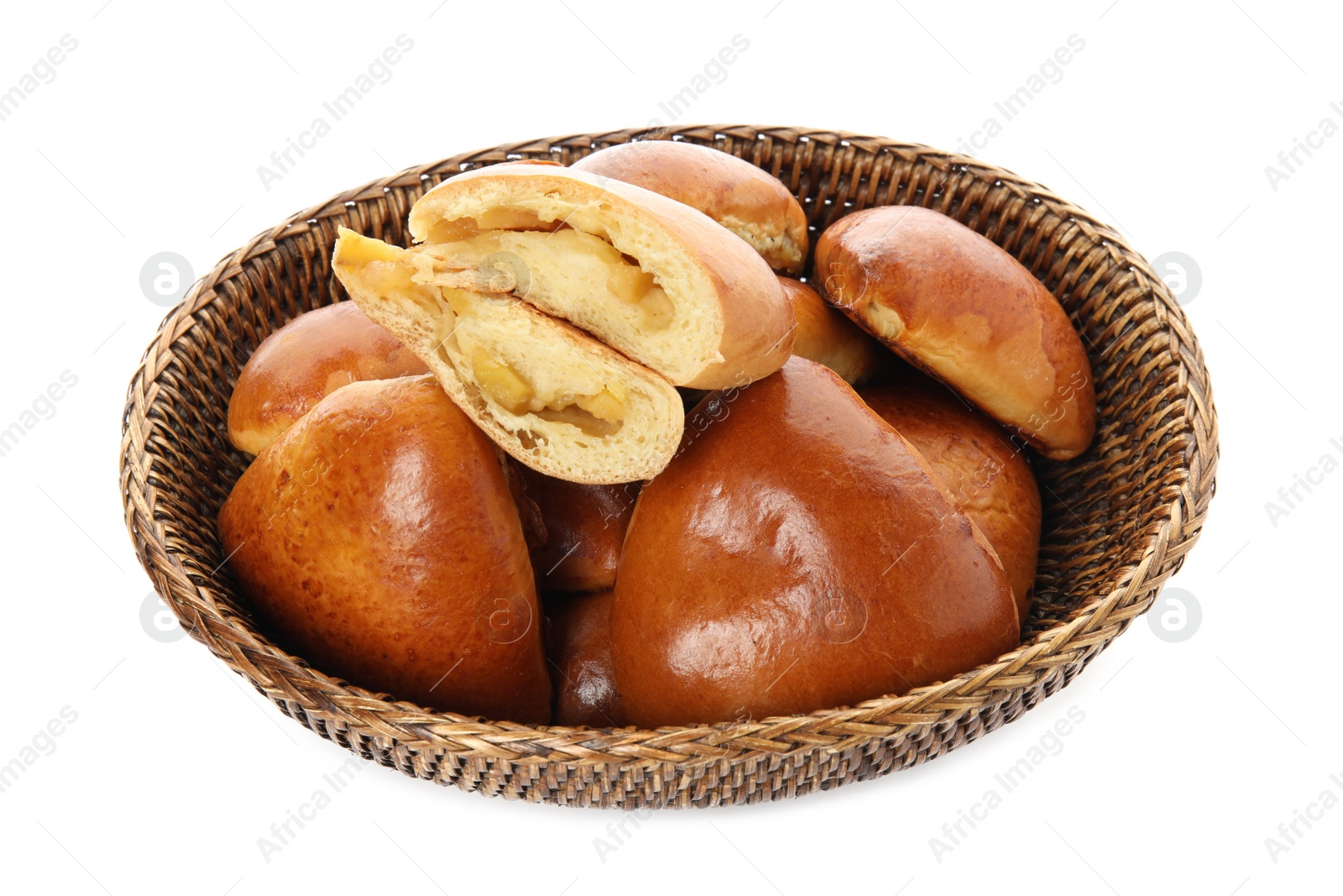 Photo of Delicious baked apple pirozhki in wicker basket on white background