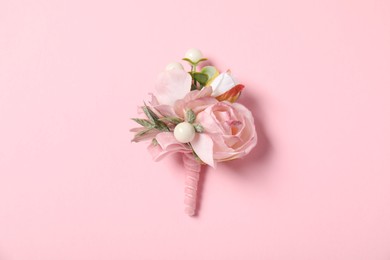 Photo of Stylish boutonniere on pink background, top view