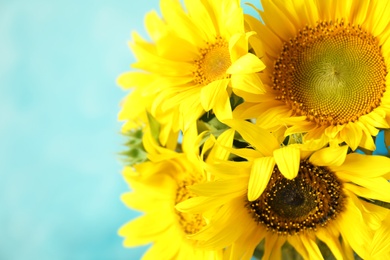 Photo of Bouquet of beautiful yellow sunflowers on color background