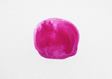 Photo of Blot of pink ink on white background, top view