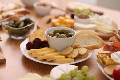 Assorted appetizers served on wooden table, closeup