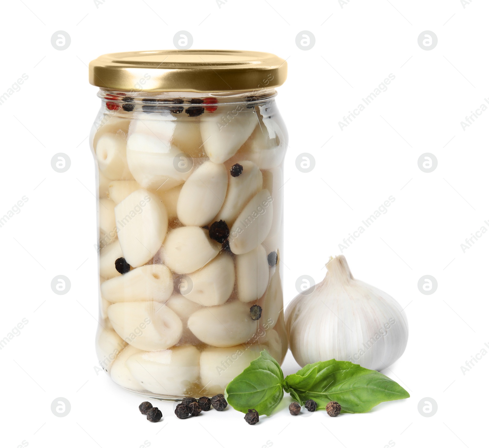 Photo of Composition with jar of pickled garlic on white background