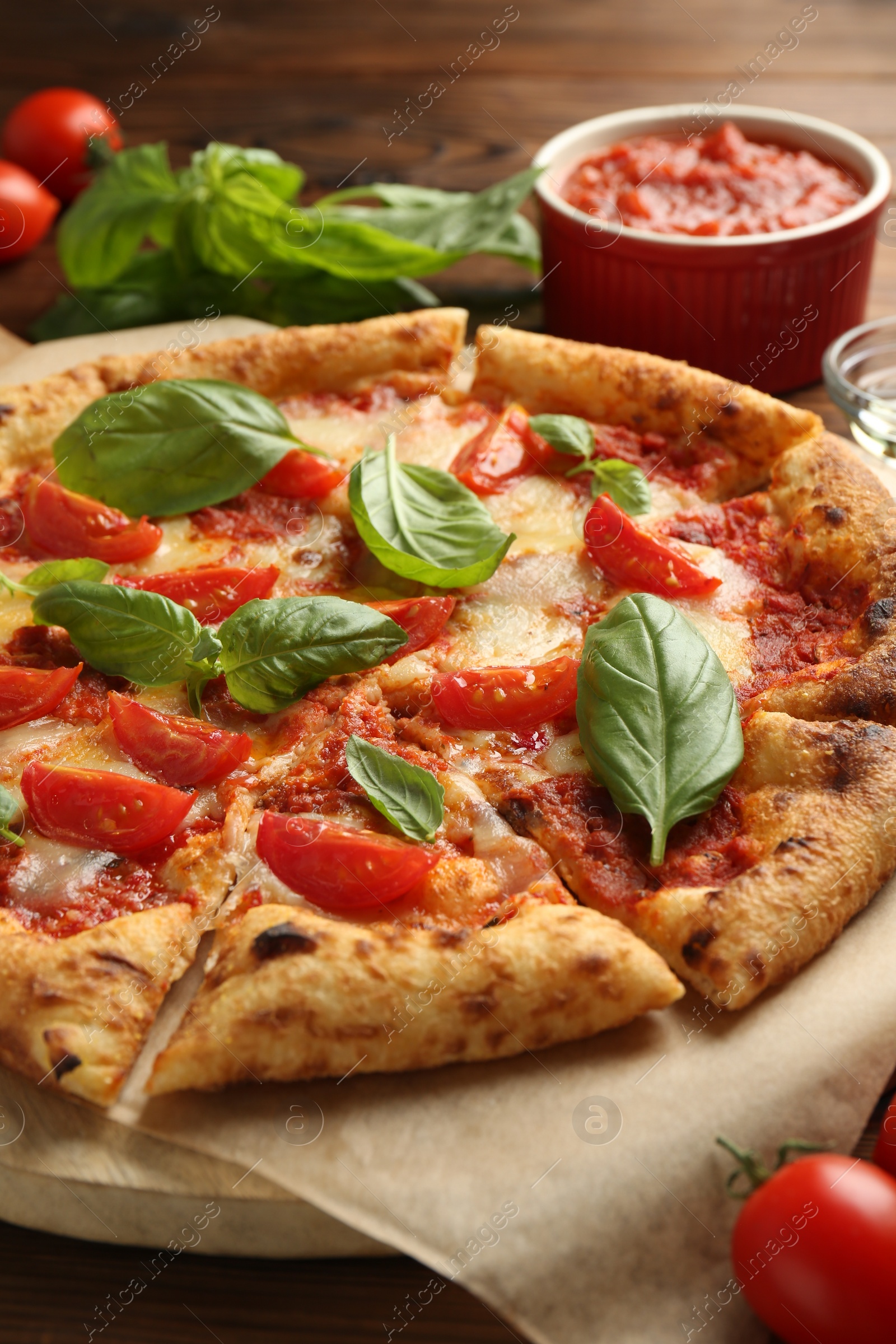 Photo of Delicious Margherita pizza on wooden table, closeup