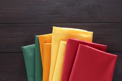 Photo of Different colorful napkins on wooden table, top view