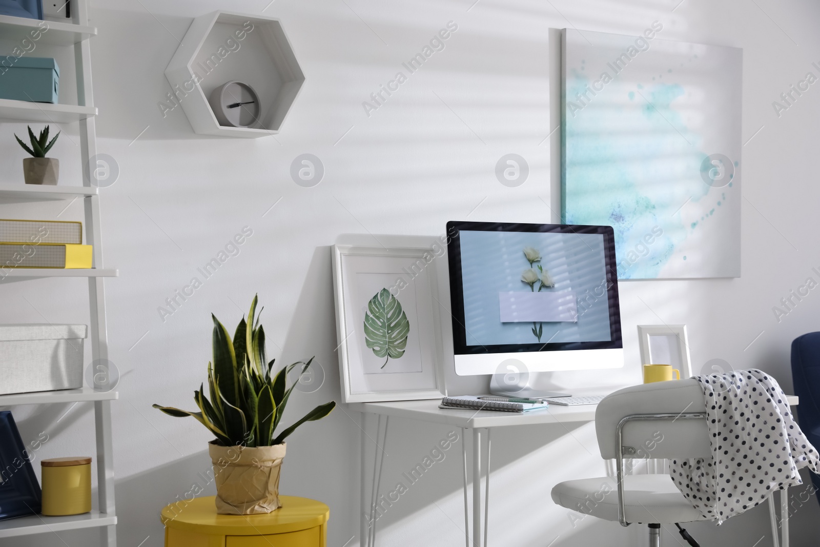 Photo of Comfortable office chair near desk with modern computer indoors