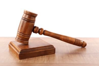 Photo of Gavel on wooden table against white background. Small mallet