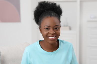 Portrait of beautiful young woman at home