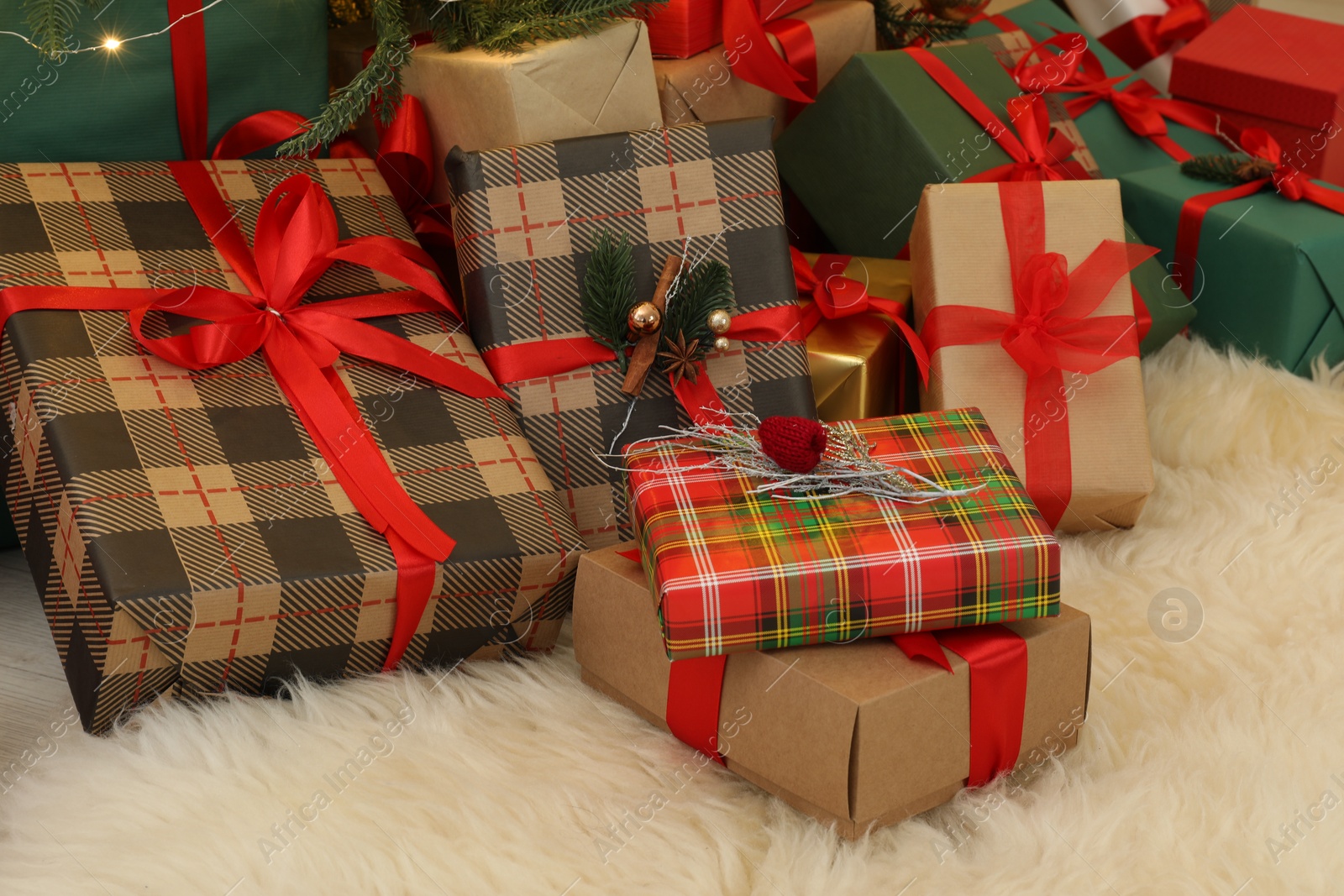 Photo of Many gift boxes on carpet in room. Christmas celebration