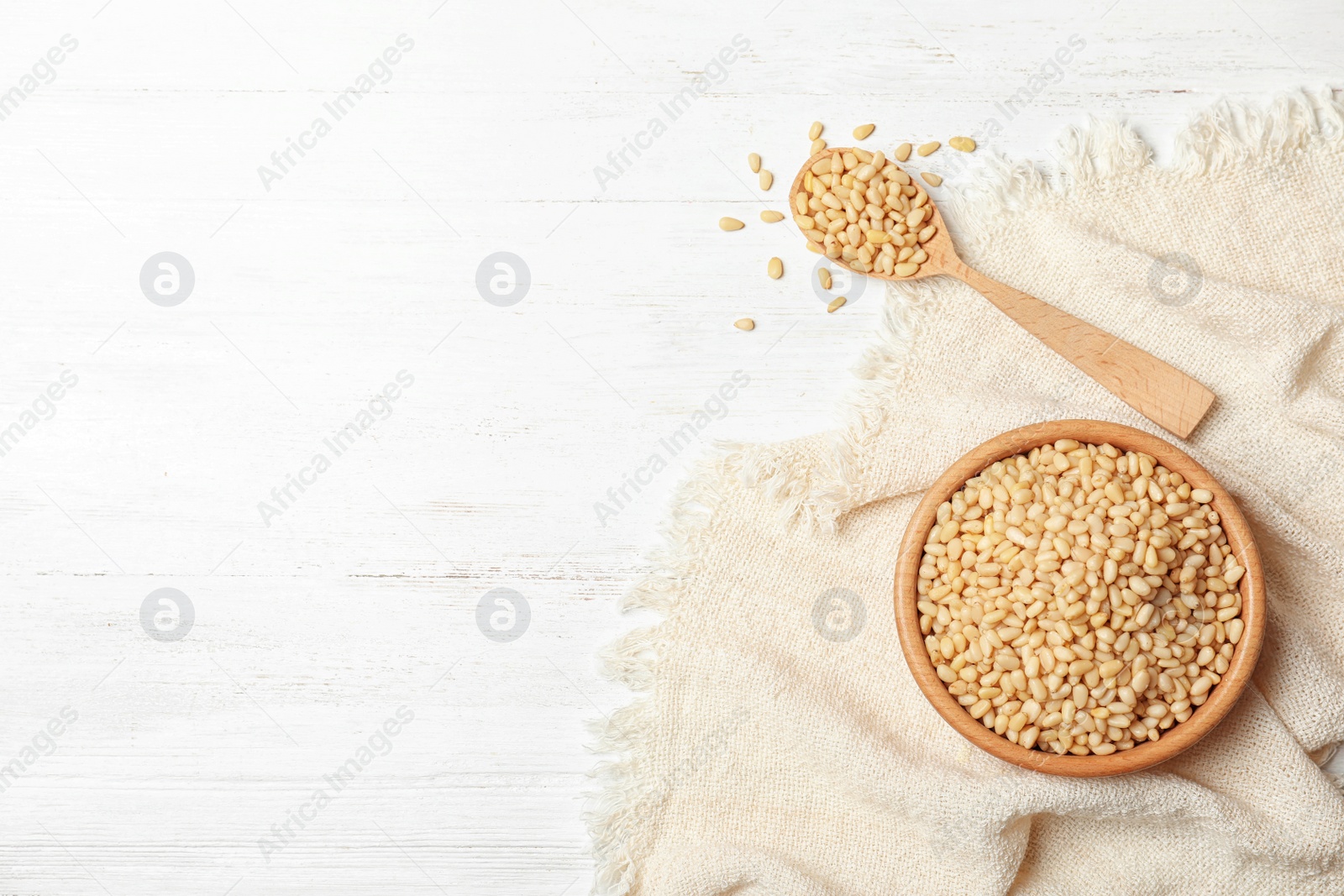 Photo of Flat lay composition with pine nuts and space for text on wooden background