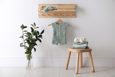 Photo of Cute children's clothes and shoes in room