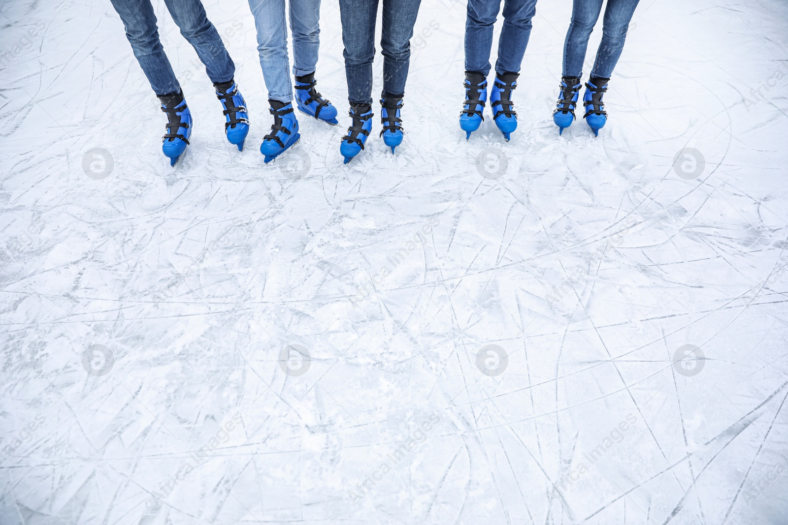 Photo of Friends at ice skating rink outdoors, closeup. Space for text