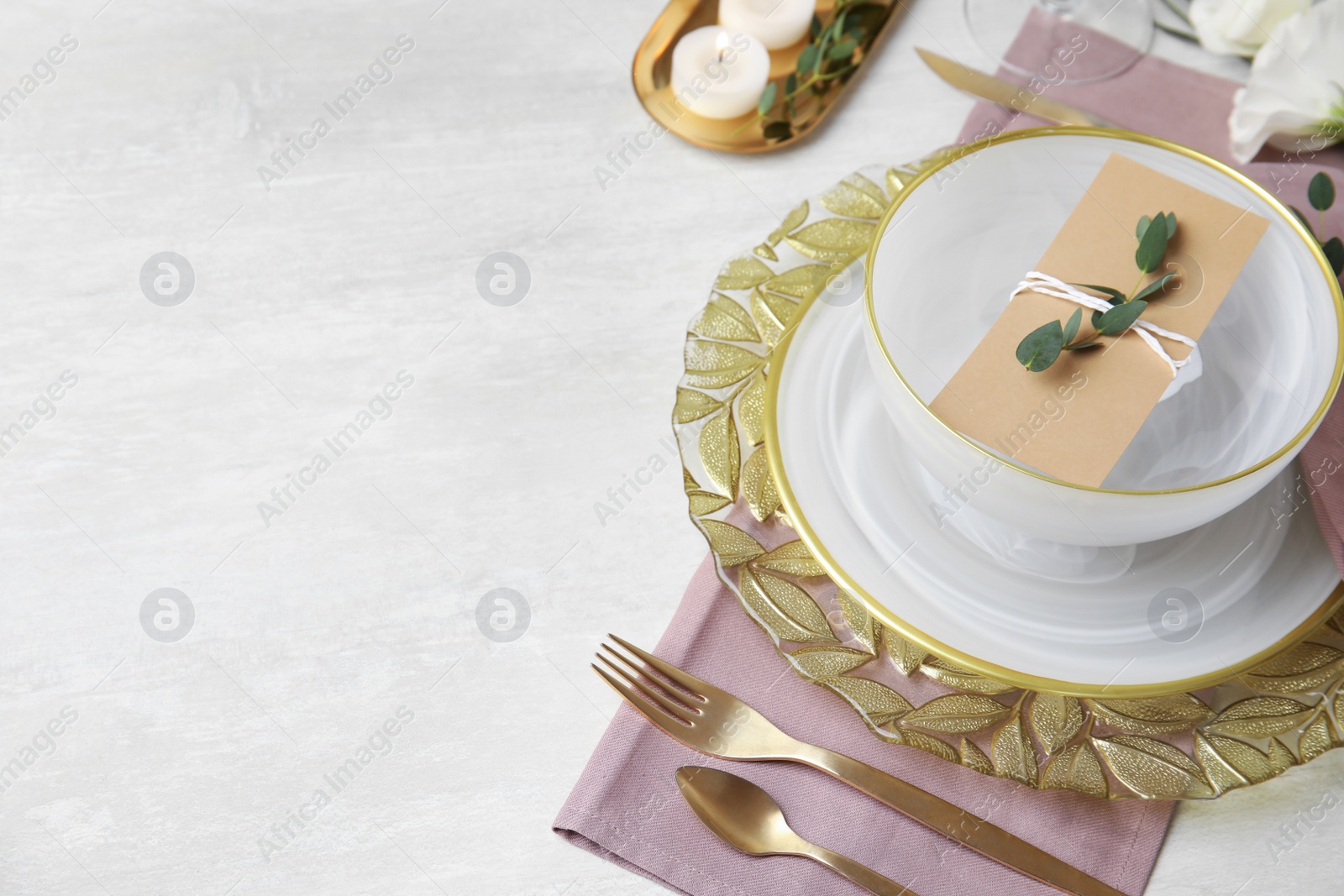 Photo of Elegant festive table setting on light background, space for text