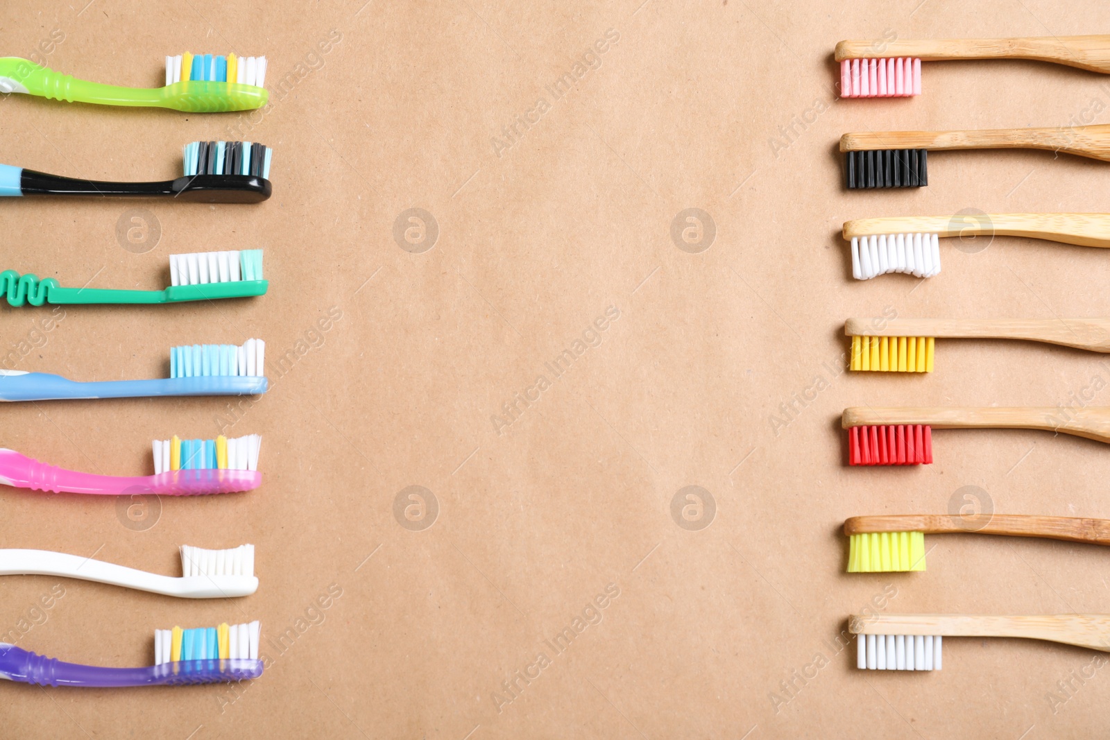 Photo of Flat lay composition with plastic and bamboo toothbrushes on beige background, space for text. Recycling concept
