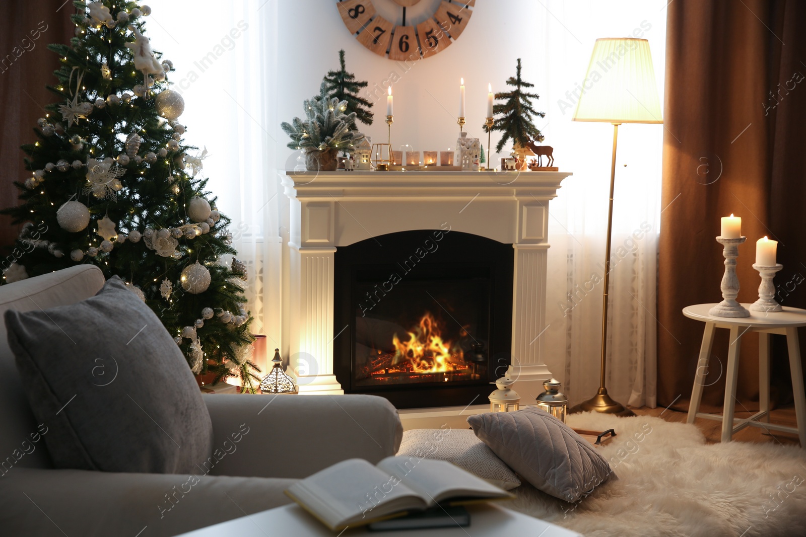 Photo of Beautiful room interior with small firs, fireplace and decorated Christmas tree