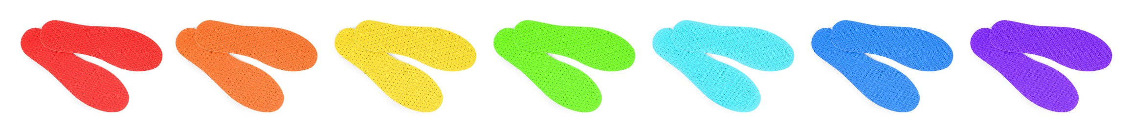 Image of Set with colorful orthopedic insoles on white background, top view. Banner design