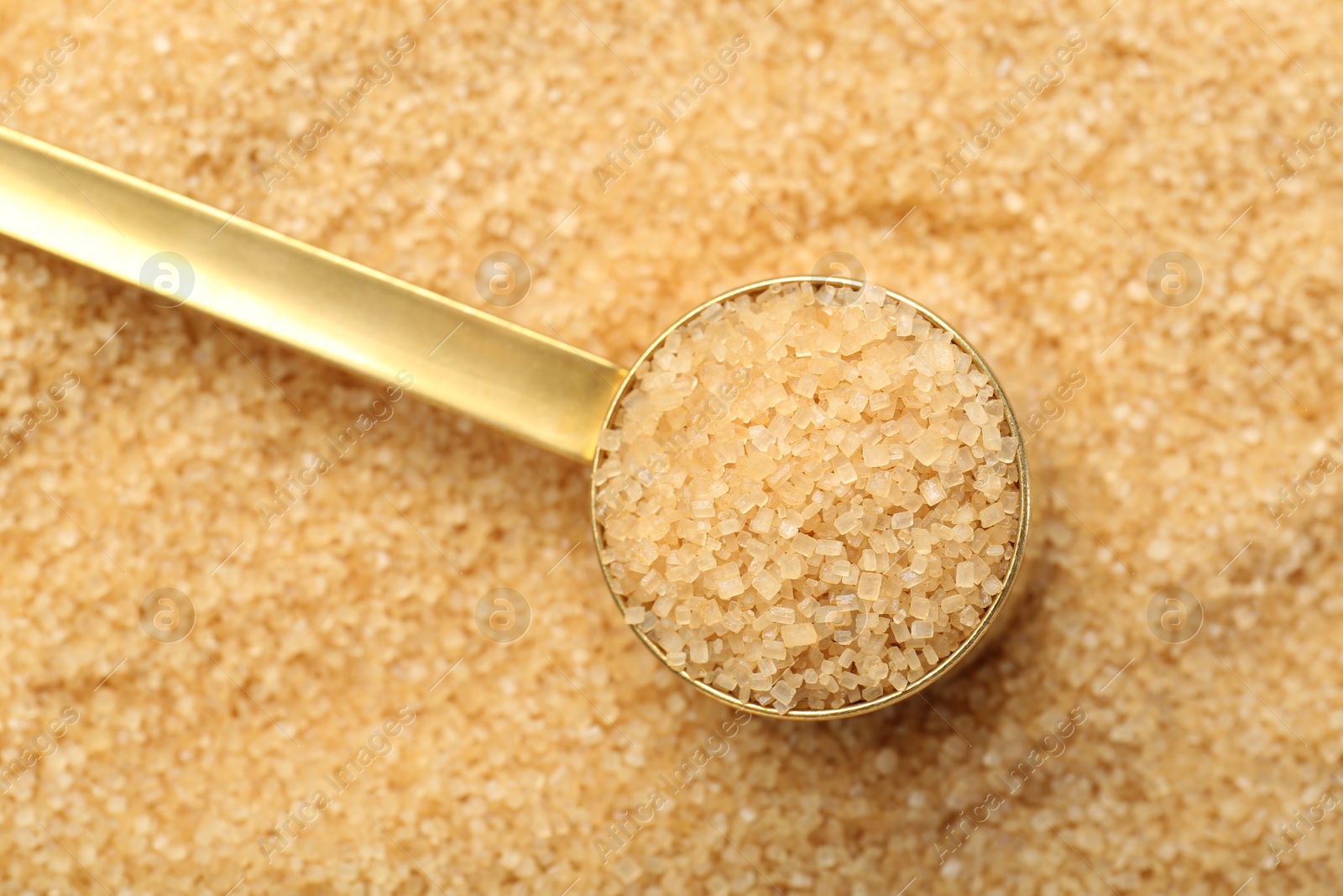 Photo of Scoop on granulated brown sugar, above view