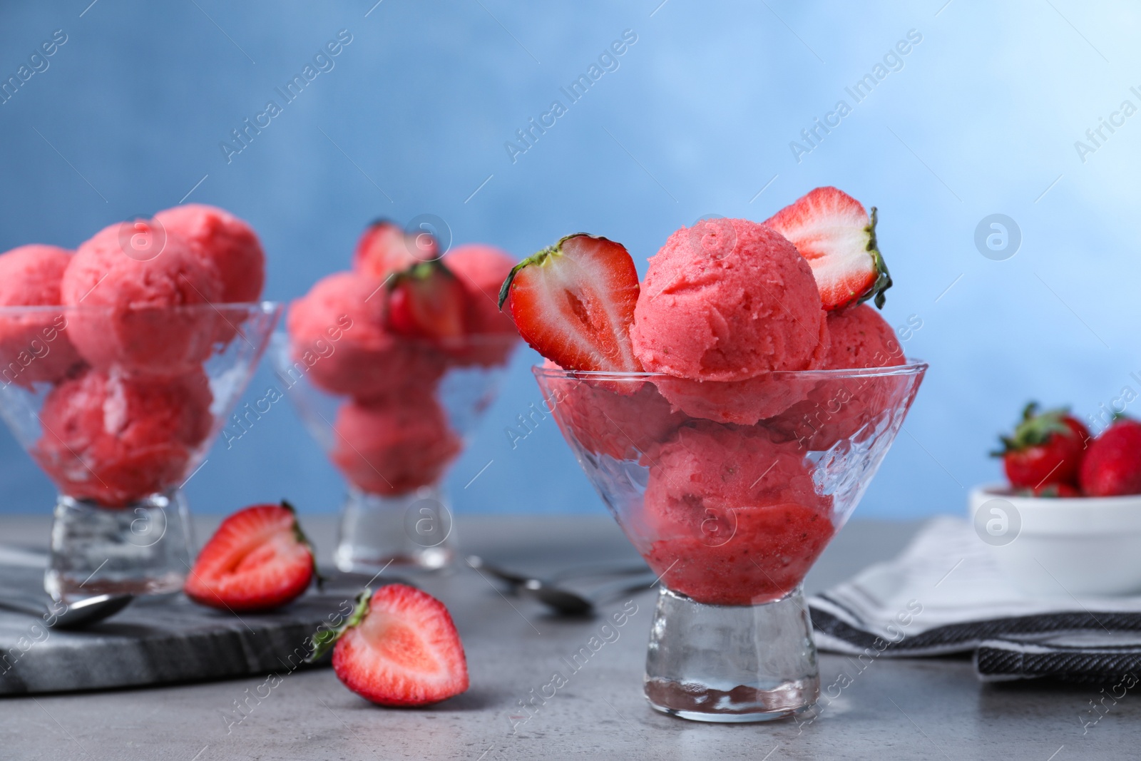 Photo of Delicious strawberry ice cream served on grey table