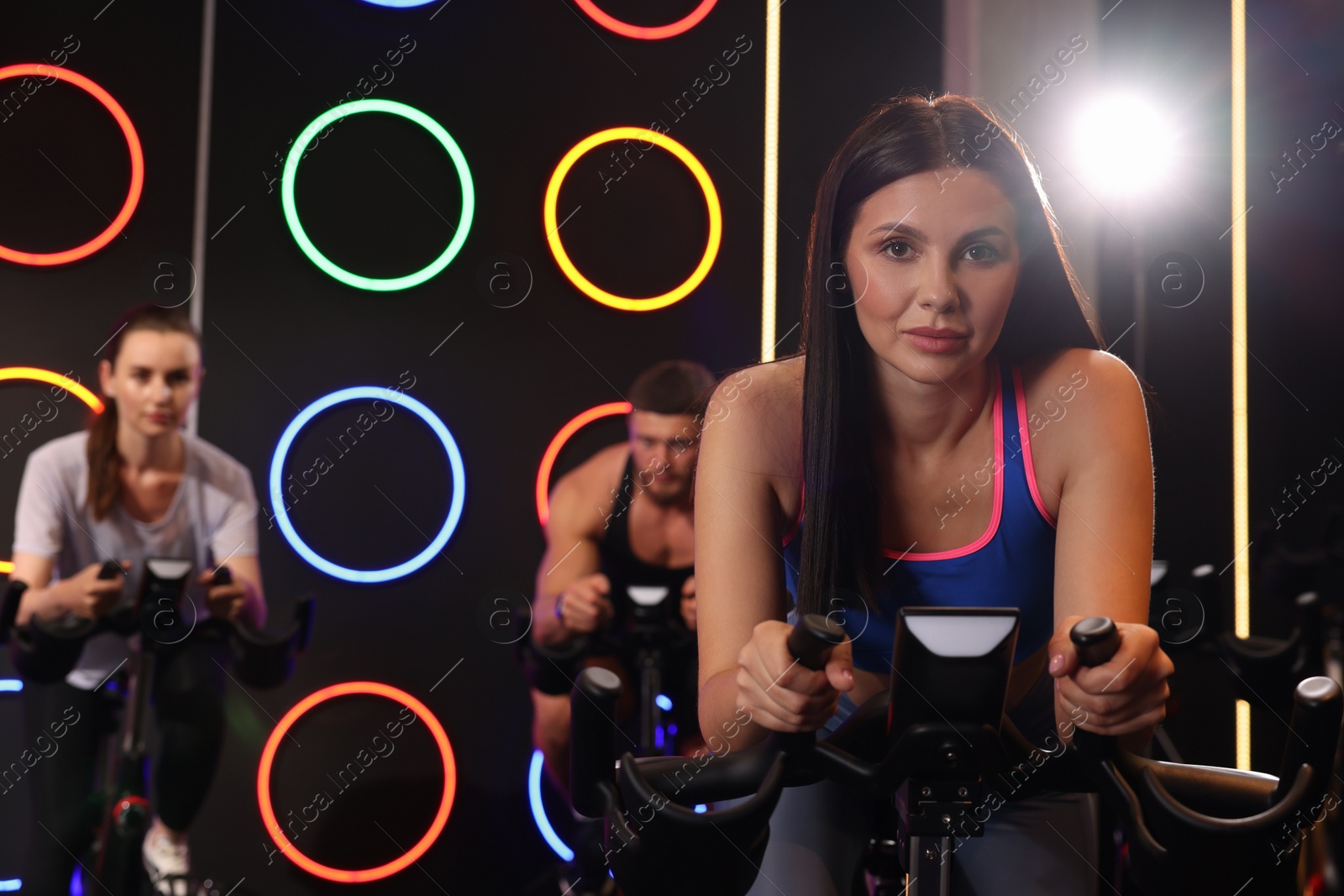 Photo of Group of people training on exercise bikes in fitness club