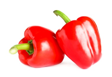 Tasty ripe red bell peppers on white background