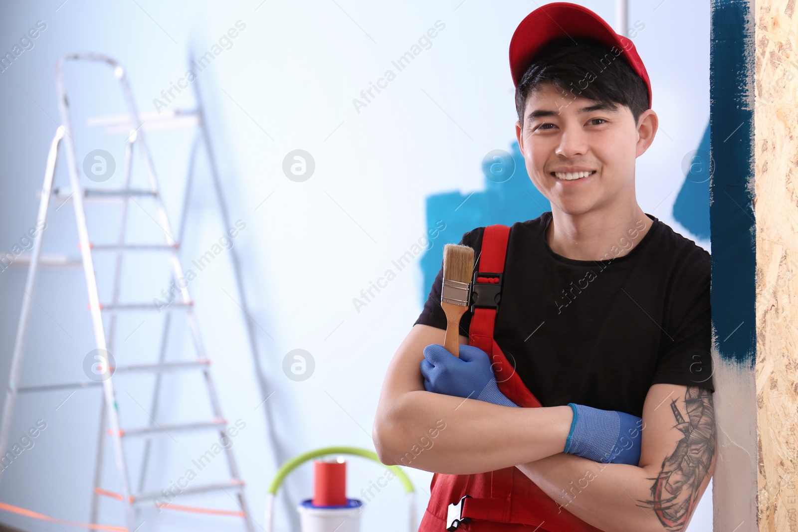 Photo of Portrait of male decorator with brush indoors