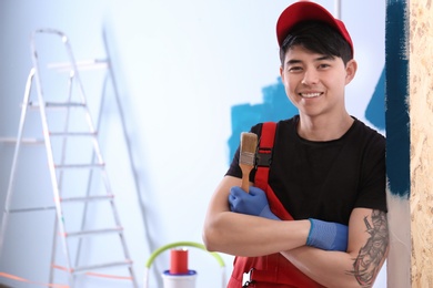 Portrait of male decorator with brush indoors