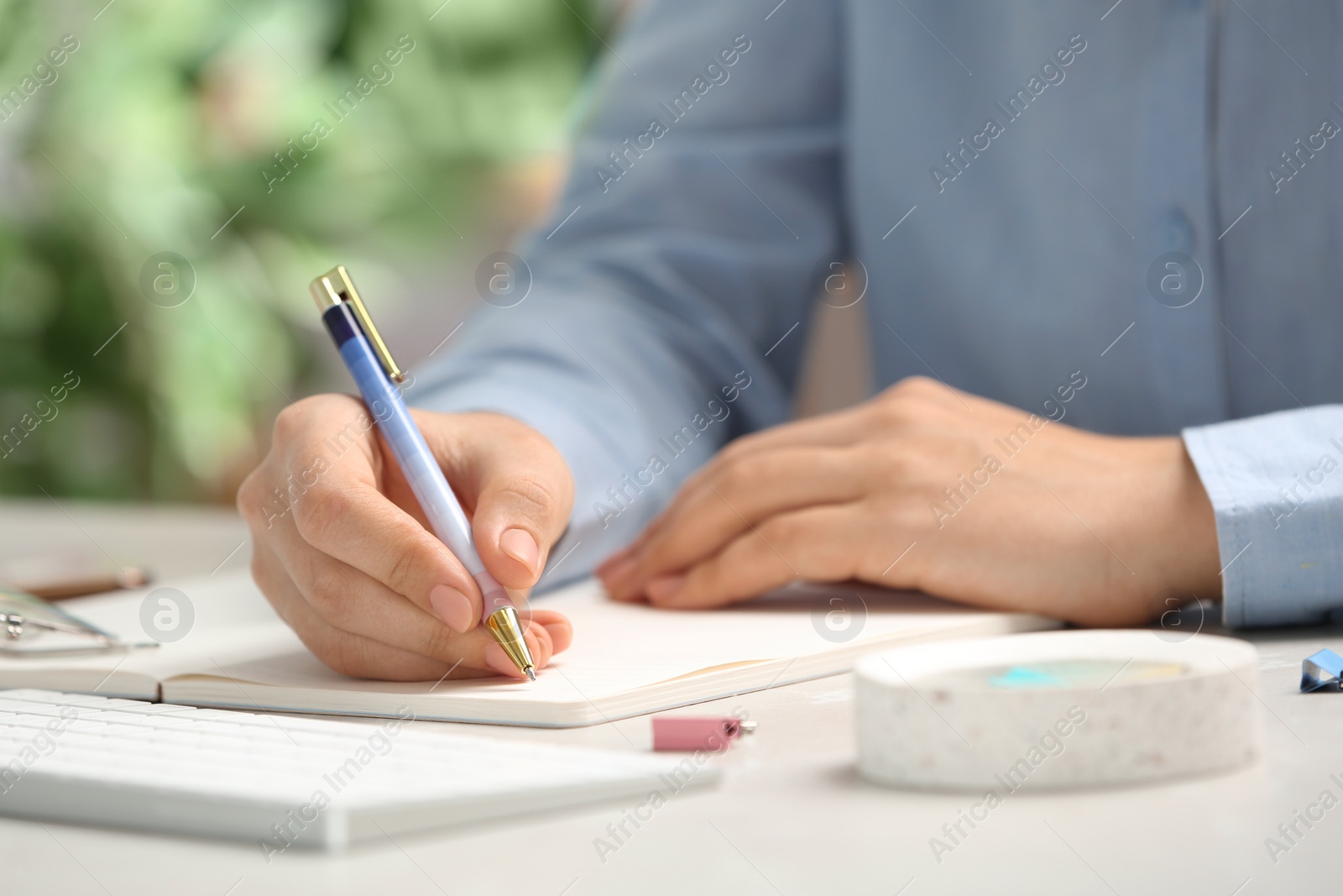 Photo of Journalist working at table in office, closeup