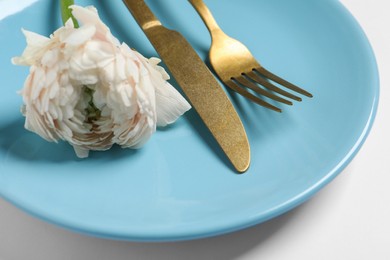 Photo of Stylish table setting with cutlery and flower on white background, closeup