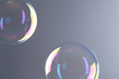 Beautiful transparent soap bubbles on gray background