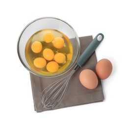 Photo of Whisk, raw eggs and bowl with yolks isolated on white, top view