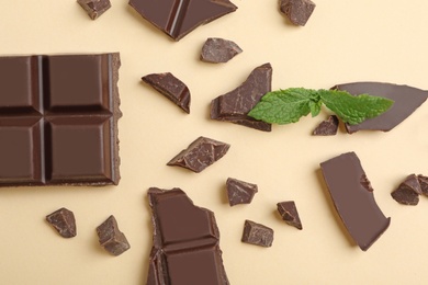 Photo of Flat lay composition with chocolate and mint on color background