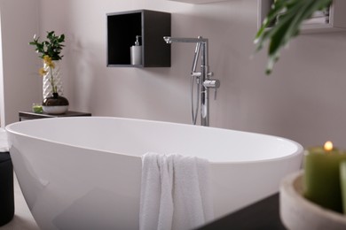 Photo of Stylish bathroom interior with modern white tub