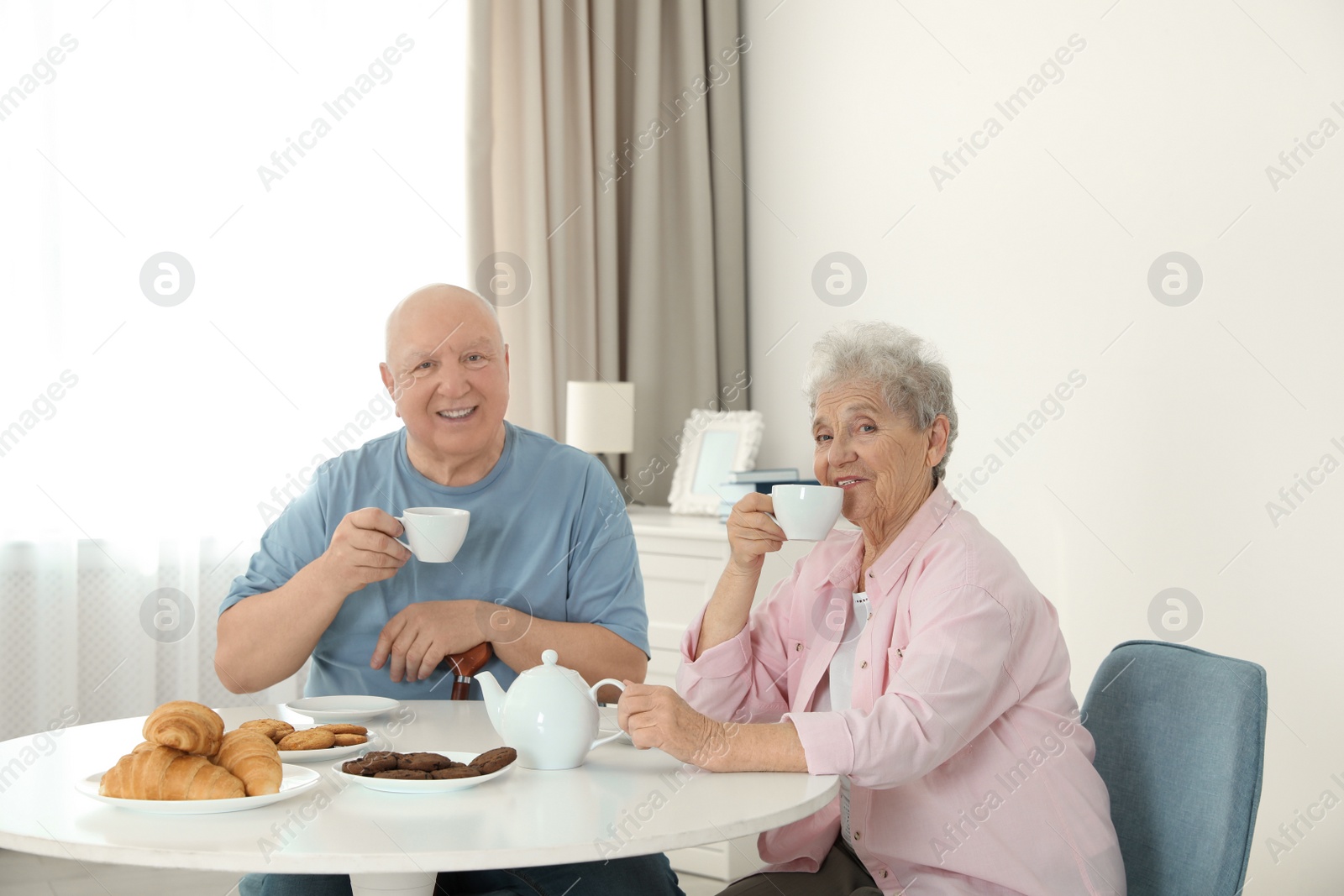 Photo of Elderly people having breakfast at nursing home. Assisting senior people