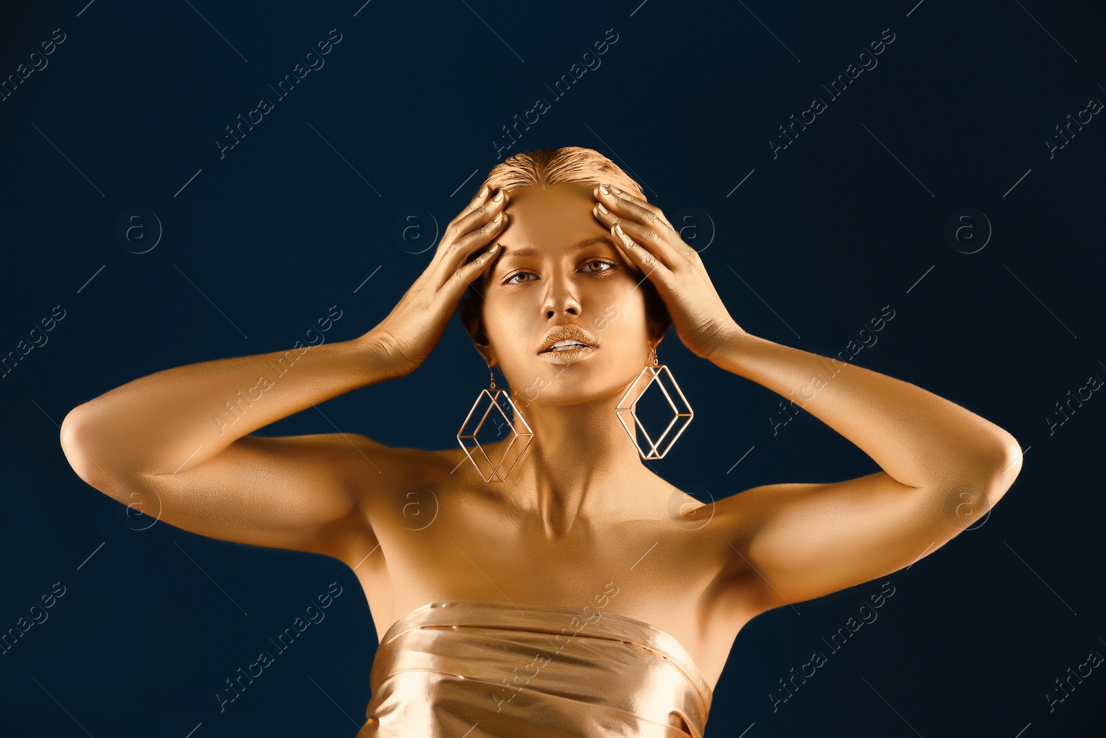 Photo of Portrait of beautiful lady with gold paint on skin against color background