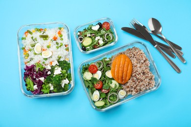 Photo of Set of glass containers with fresh food and cutlery on light blue background, flat lay