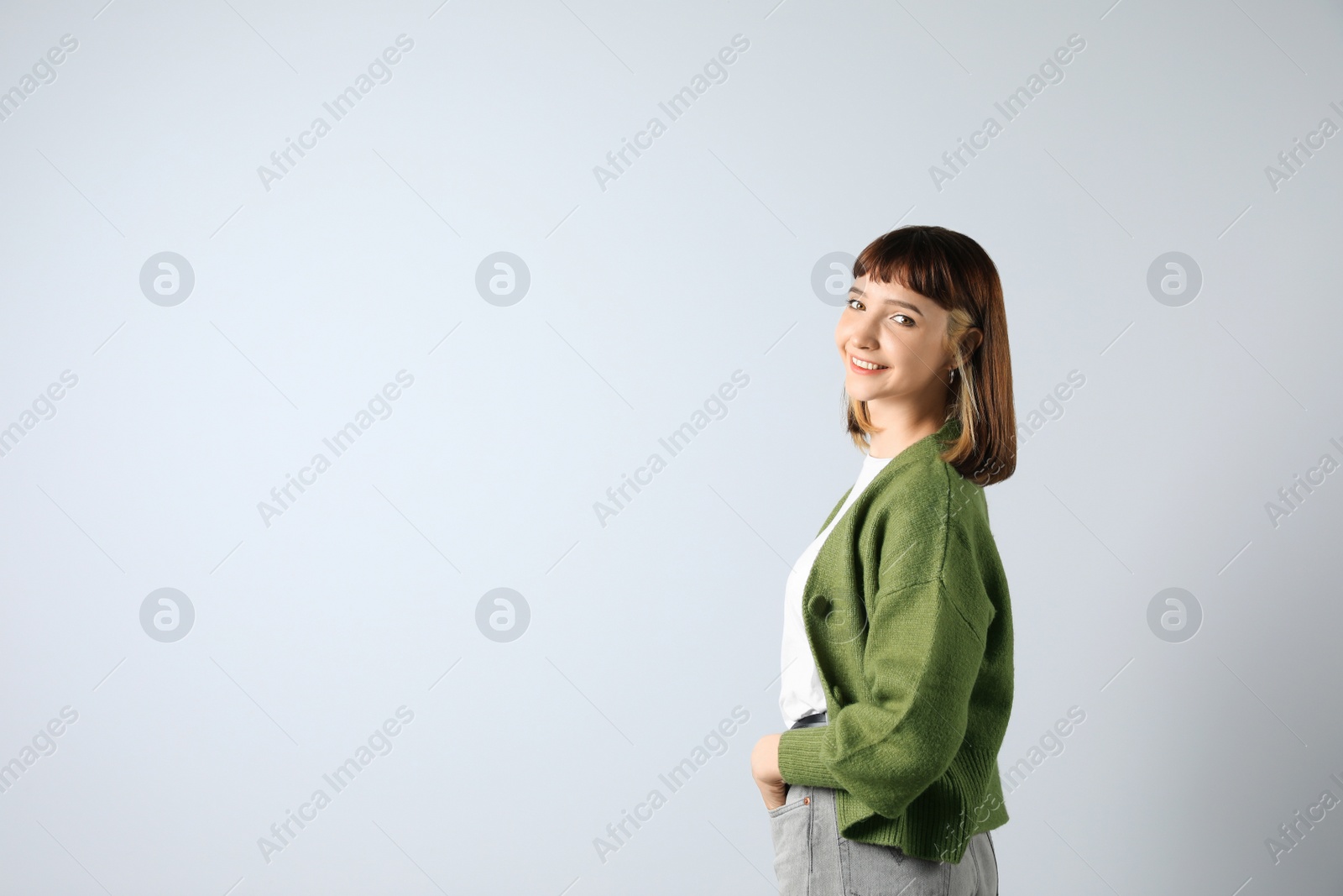 Photo of Beautiful young girl smiling on white background. Space for text