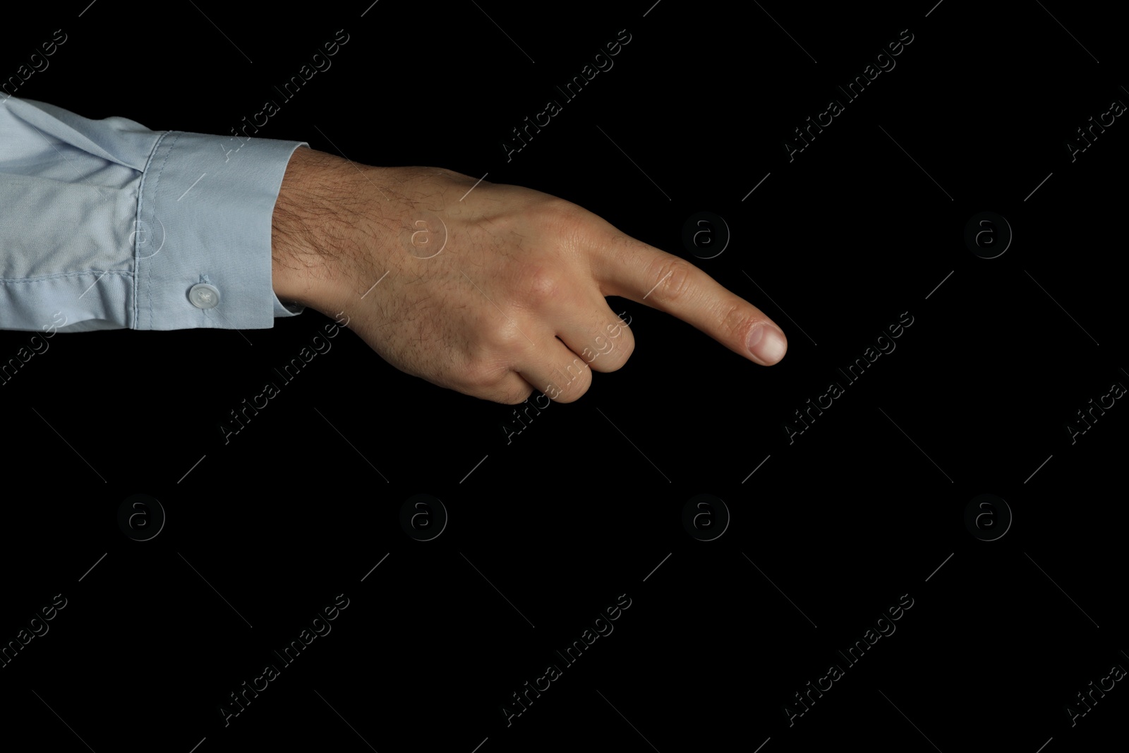 Photo of Man pointing at something on black background, closeup