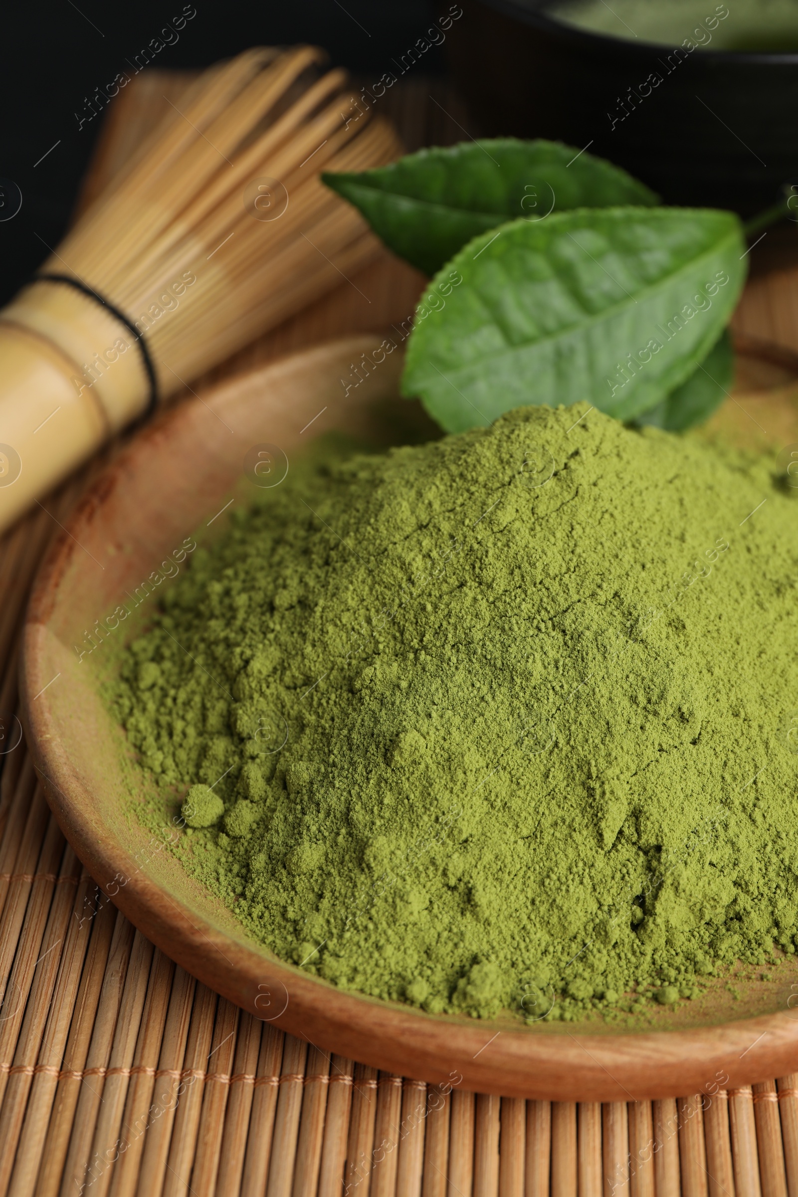 Photo of Green matcha powder on bamboo mat, closeup