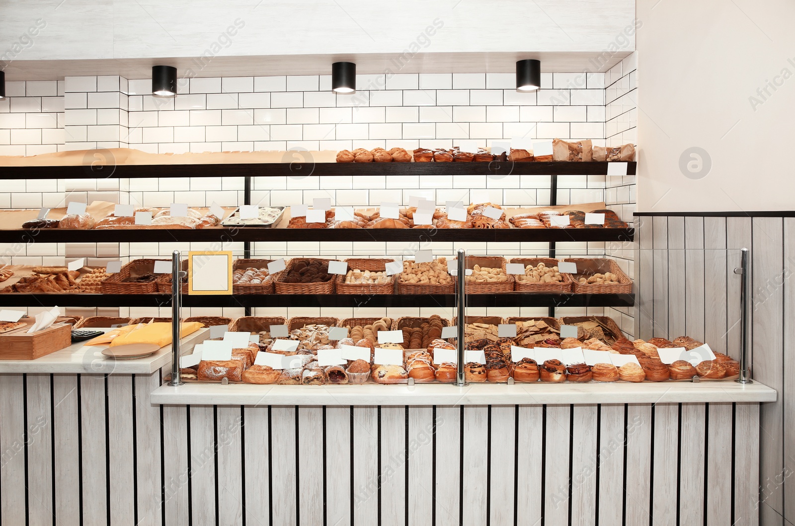 Photo of Showcase with different pastries in bakery shop