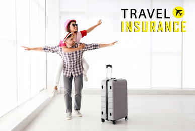 Image of Travel insurance concept. Young couple with suitcase in airport