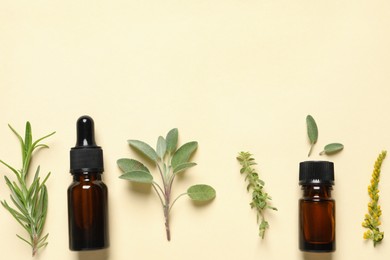 Photo of Bottles of essential oils and different herbs on beige background, flat lay. Space for text