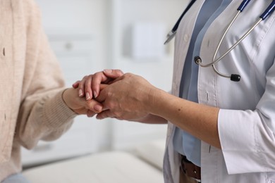 Photo of Professional doctor working with patient in hospital, closeup