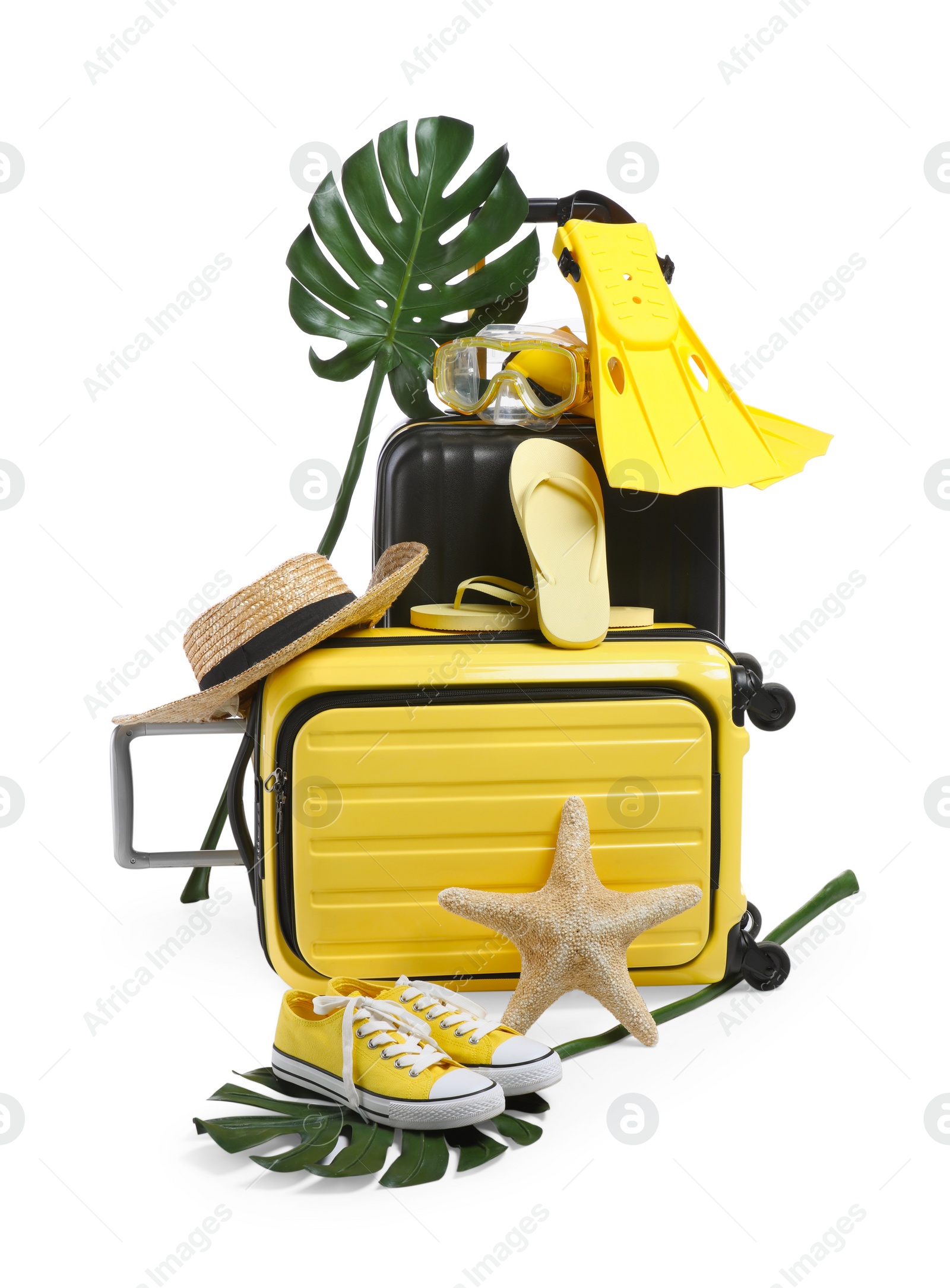 Photo of Suitcases with beach accessories and shoes isolated on white. Summer vacation