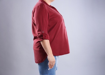 Photo of Fat woman on grey background, space for text. Weight loss