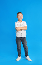 Portrait of cute little boy on blue background