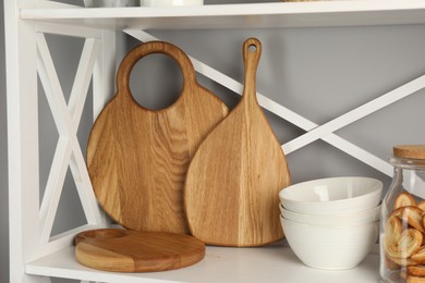 Wooden cutting boards, bowls and french palmier cookies on shelving unit