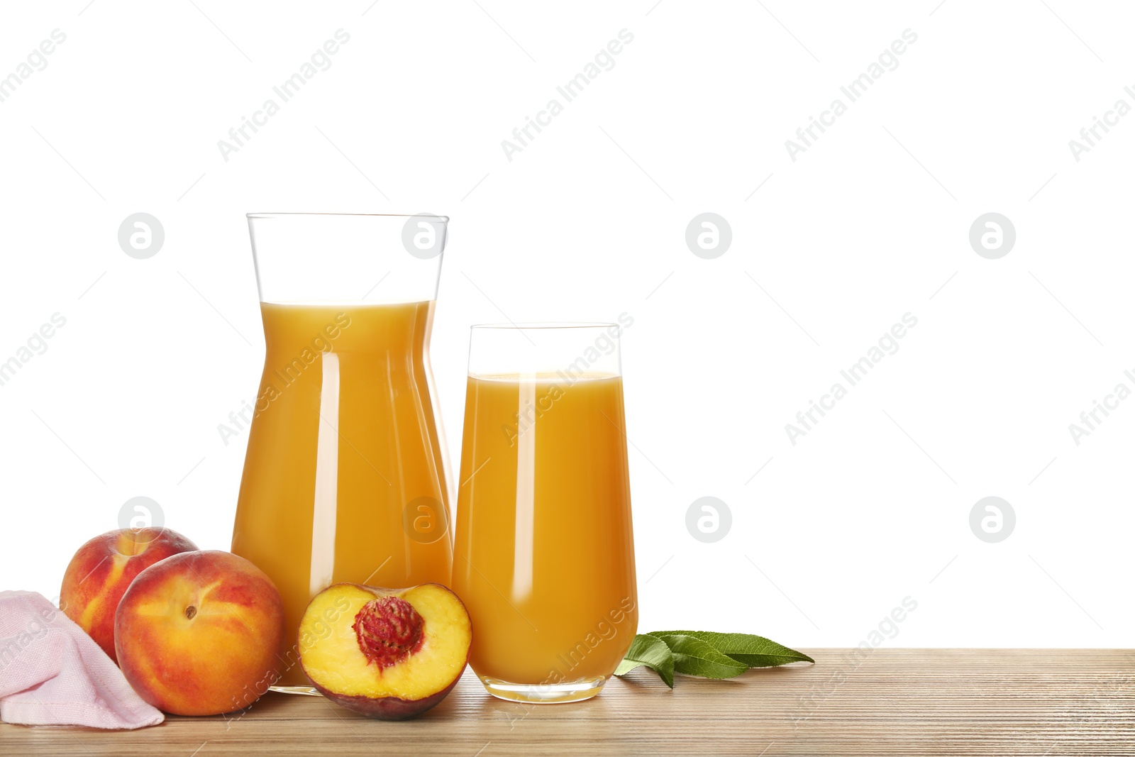 Photo of Freshly made tasty peach juice on wooden table against white background