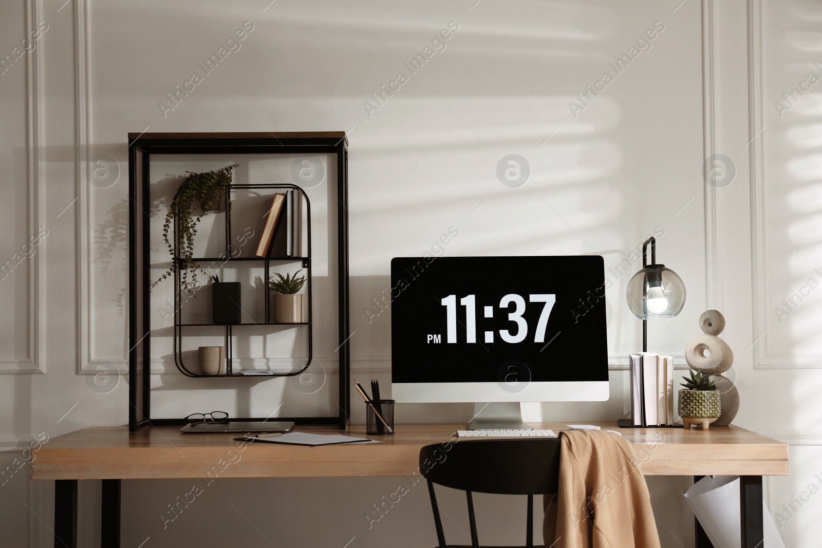 Photo of Modern computer and laptop on wooden desk in room. Interior design