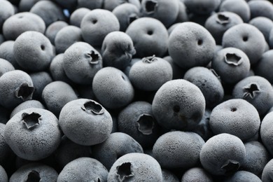 Photo of Tasty frozen blueberries as background, closeup view