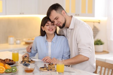 Happy couple spending time together during breakfast at home